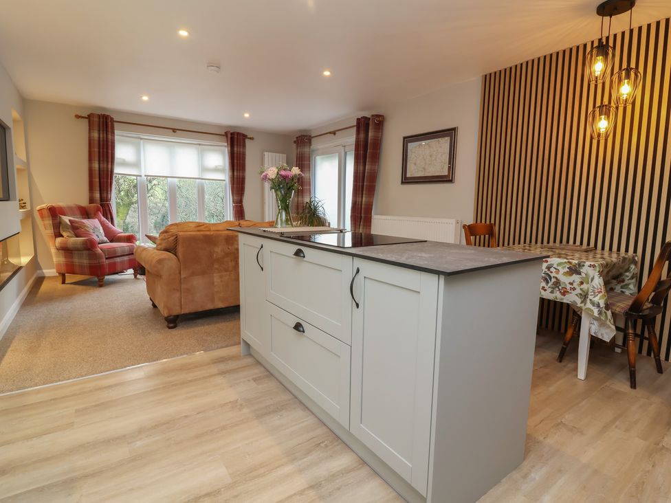 A living room with a kitchen island and seating area at Little Willesleigh Goodleigh near Barnstaple