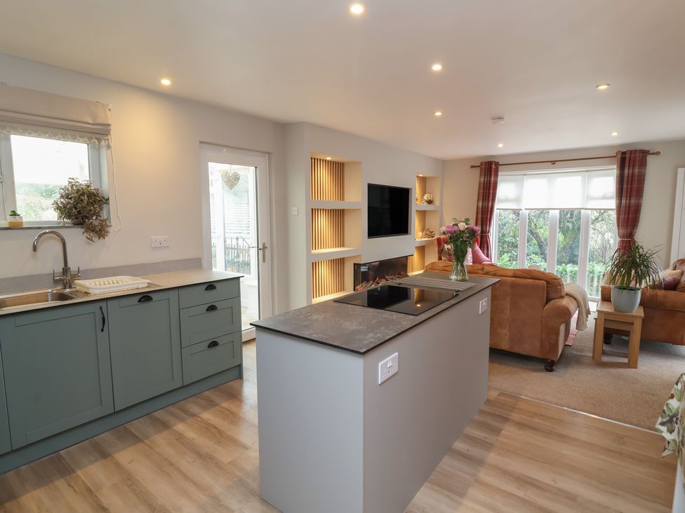 A kitchen with an island and seating area at Little Willesleigh Goodleigh near Barnstaple