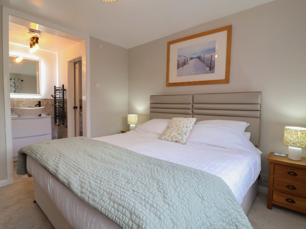 A bedroom with a bed and nightstand at Little Willesleigh in Goodleigh near Barnstaple