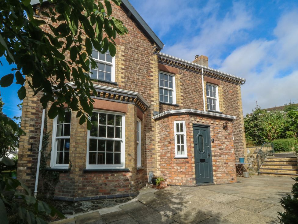 A brick house with a door and windows at Gweryl Lodge in Conwy