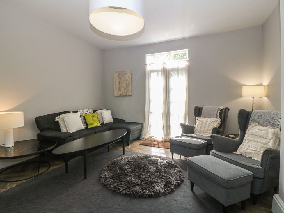 A living room with a sofa and armchairs at Gweryl Lodge in Conwy