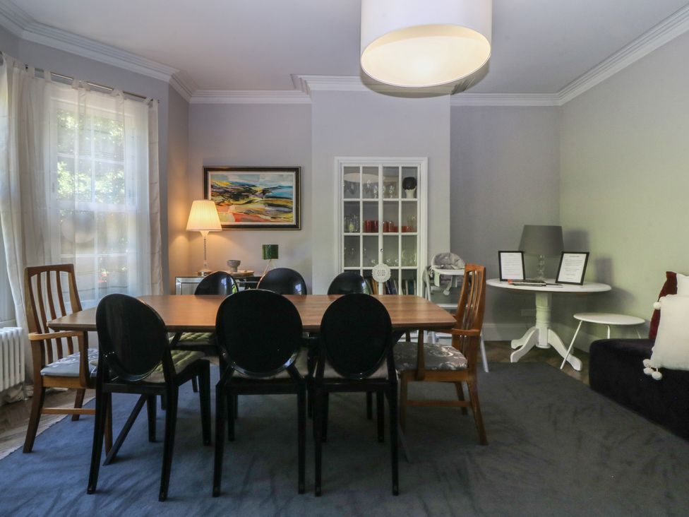 A dining room with a table and chairs at Gweryl Lodge in Conwy