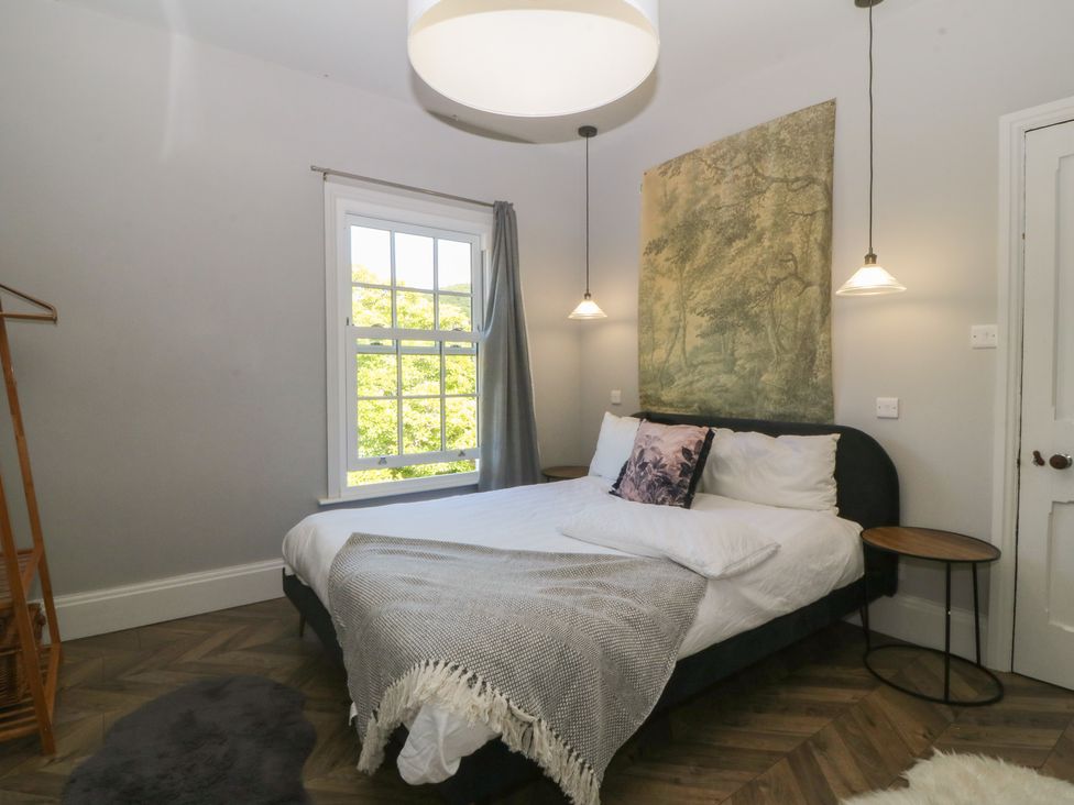 A bedroom with a bed and a window at Gweryl Lodge in Conwy