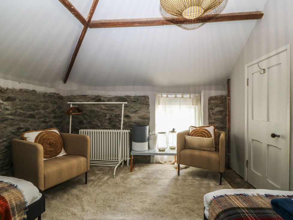 A sitting room with chairs and a table at Gweryl Lodge in Conwy