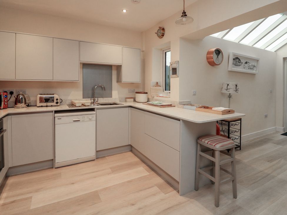 A kitchen with modern appliances and countertop at Full Deck in Dartmouth