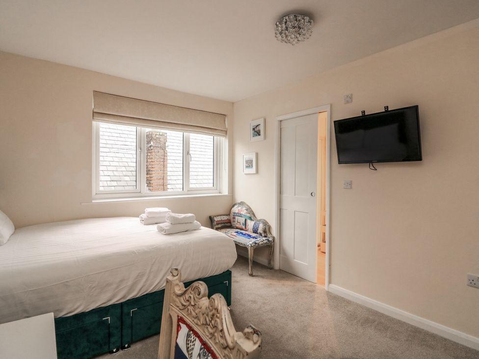 A bedroom with a bed towels on top at Full Deck in Dartmouth