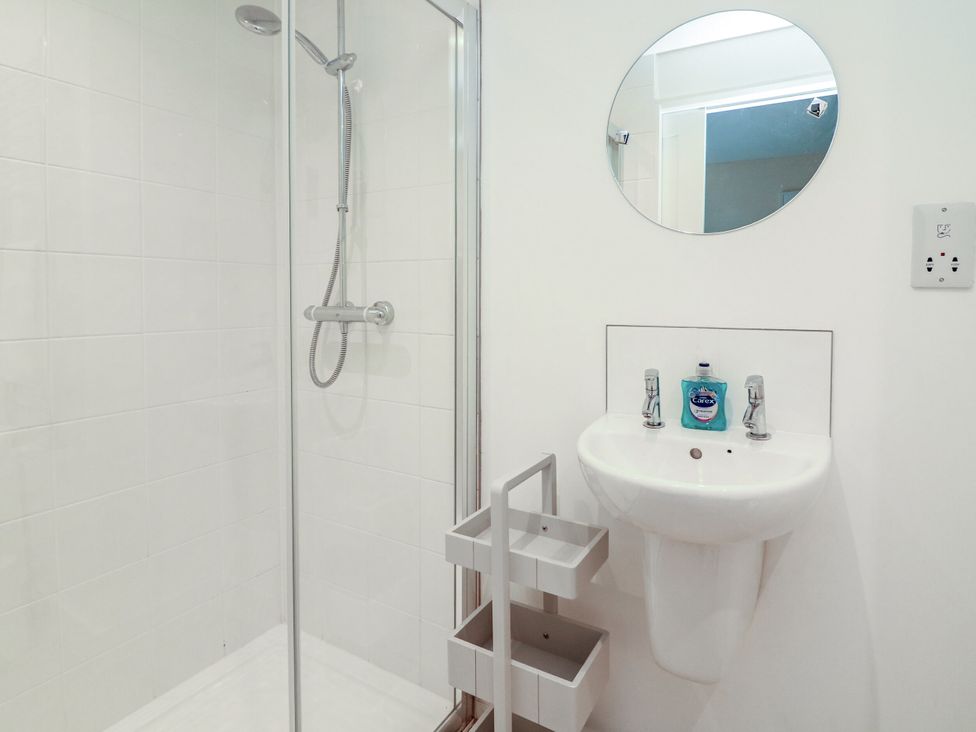 A bathroom with a shower and a sink at Full Deck in Dartmouth