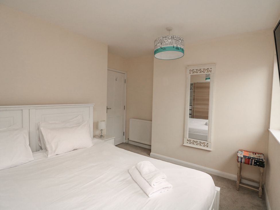 A bedroom with a bed and a mirror at Full Deck in Dartmouth