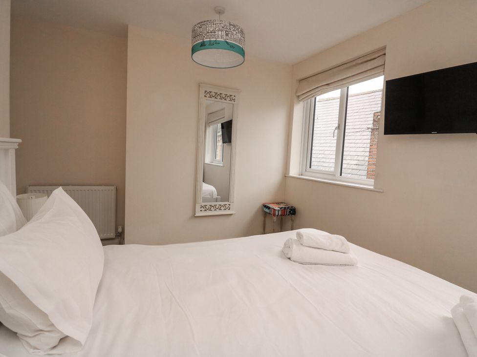 A bedroom with a bed and a television at Full Deck in Dartmouth