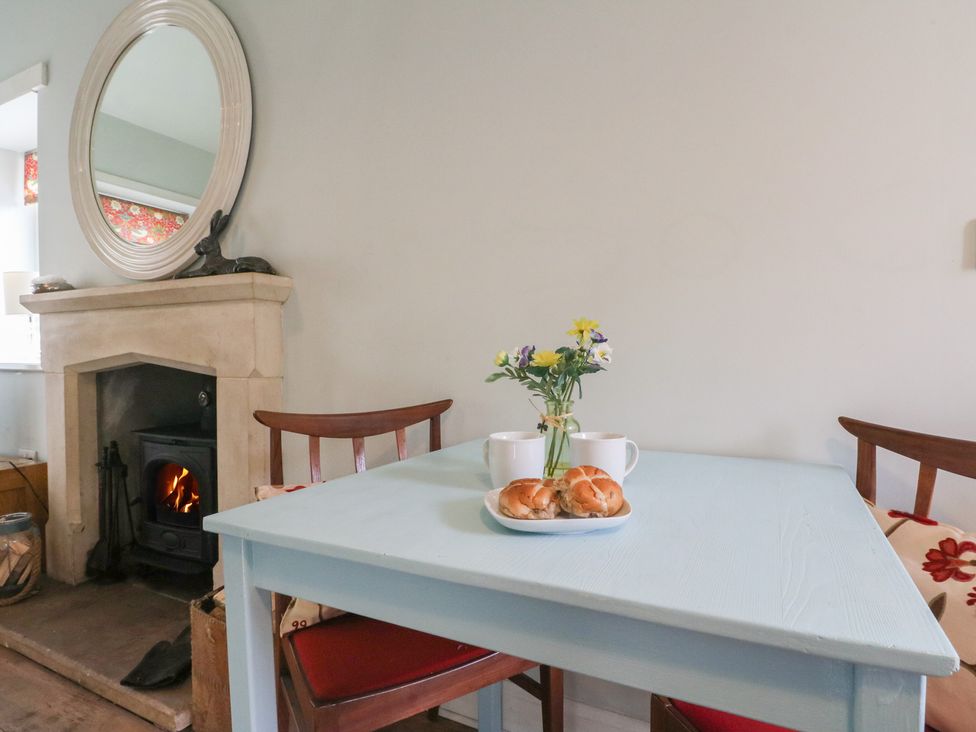 A dining room with a table set for tea and a fireplace at South Lodge Ardpatrick near Tarbert