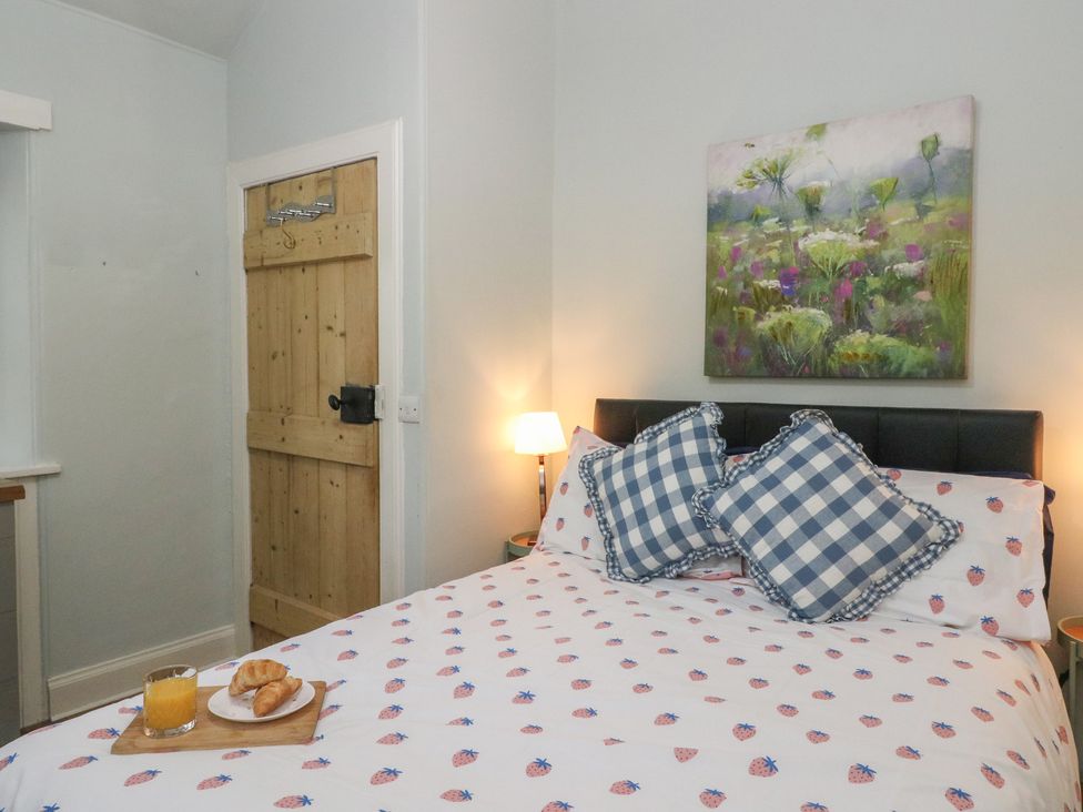 A bedroom with a bed, pillows, croissants, and juice at South Lodge in Ardpatrick near Tarbert