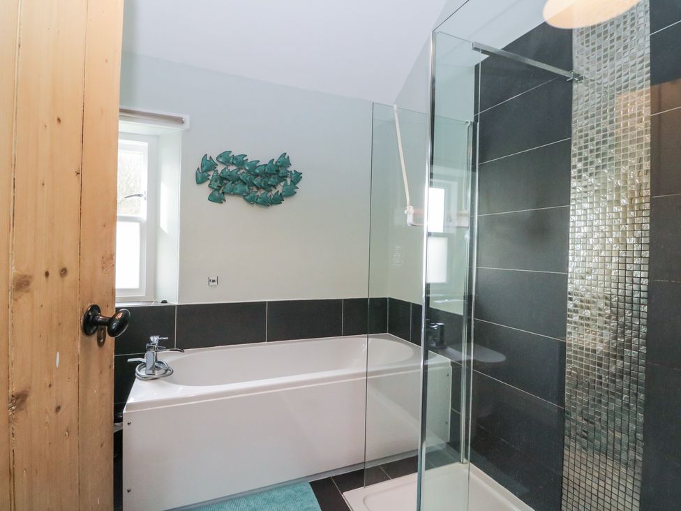 A bathroom featuring a bathtub and a shower at South Lodge in Ardpatrick near Tarbert