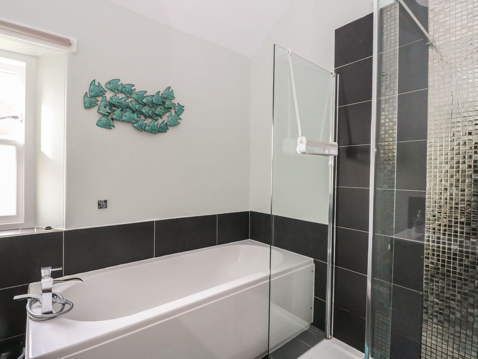 A bathroom with a bathtub and shower at South Lodge in Ardpatrick near Tarbert