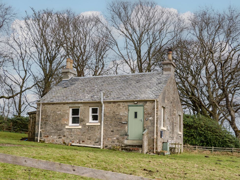 A house with a green door and chimney at South Lodge in Ardpatrick near Tarbert