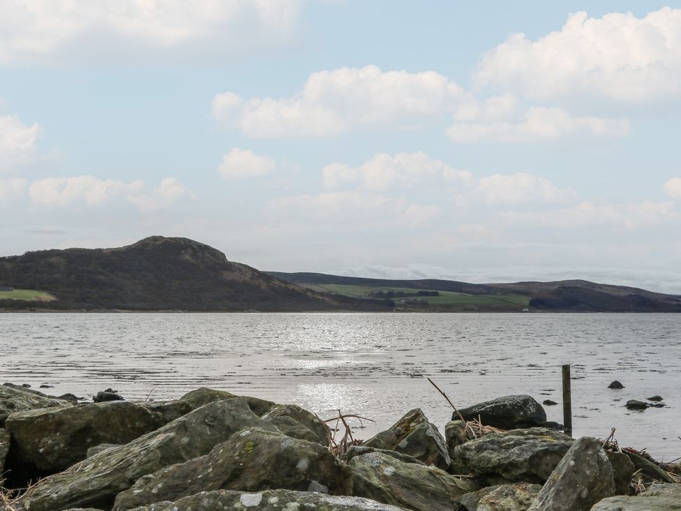 A view of hills and water with rocks in foreground at South Lodge Ardpatrick near Tarbert