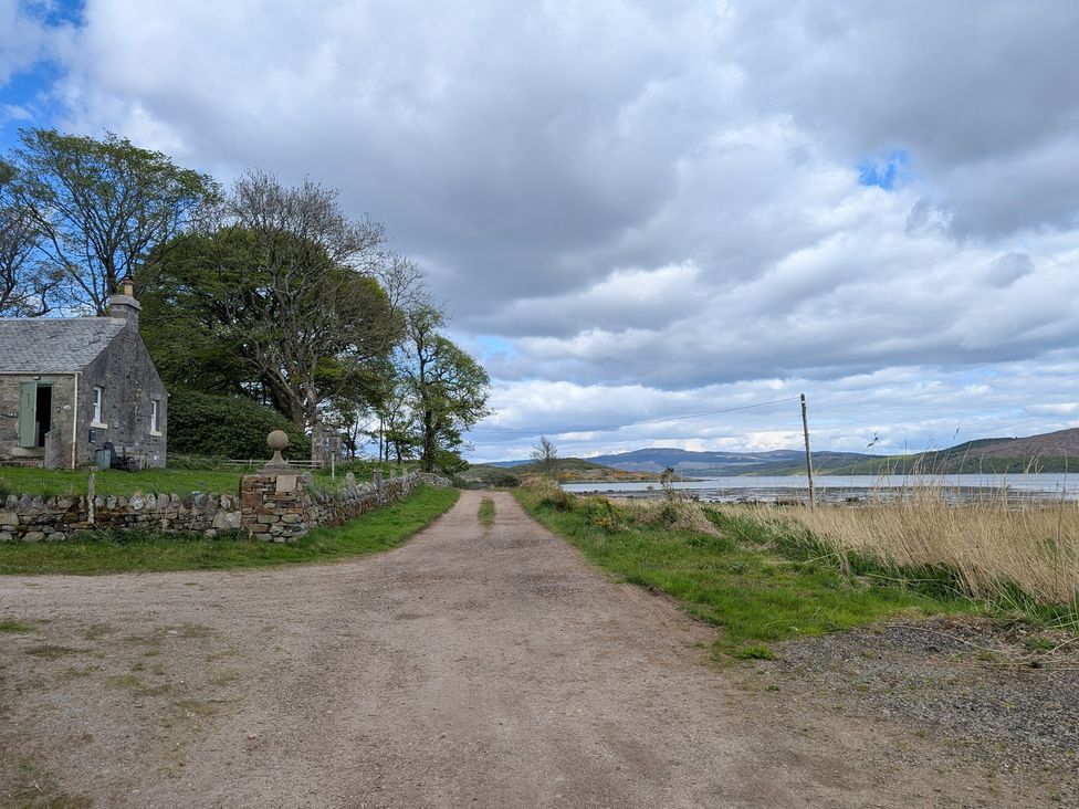 A view of a house near a road and water at Ardpatrick South Lodge Ardpatrick near Tarbert