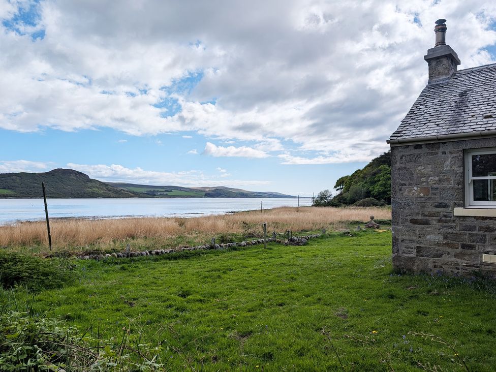 A view of a house next to water at Ardpatrick South Lodge in Ardpatrick near Tarbert
