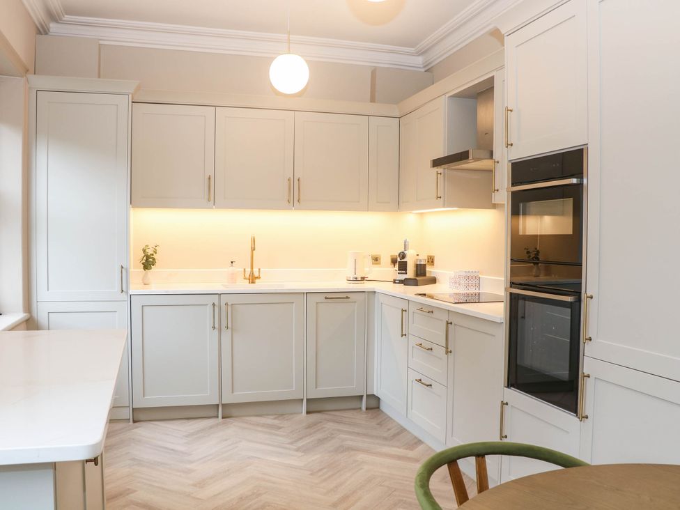 A kitchen with cabinets and appliances at Pavilion Suite in Buxton