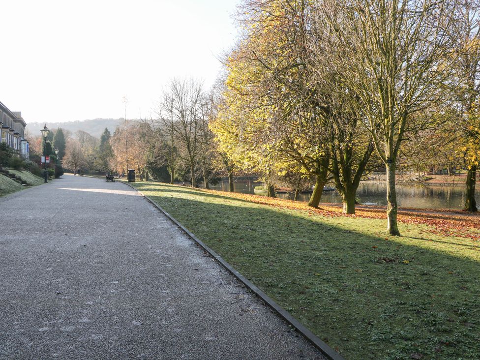 A pathway along the water surrounded by trees at Pavilion Suite in Buxton