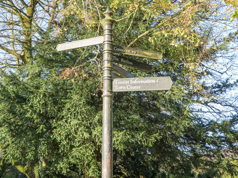 A signpost with directions at Pavilion Suite in Buxton