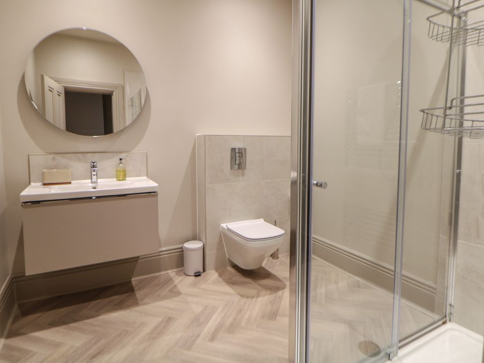 A bathroom with a sink, toilet, and shower at Pavilion Suite in Buxton
