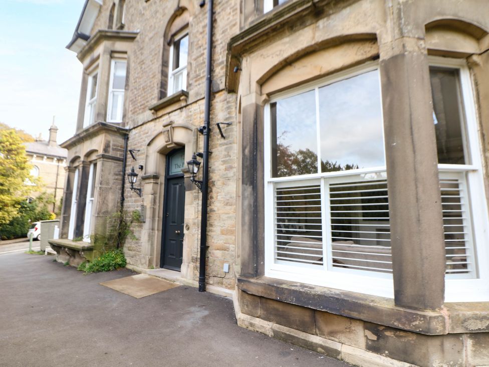 An exterior view of a building with windows and a door at Pavilion Suite in Buxton