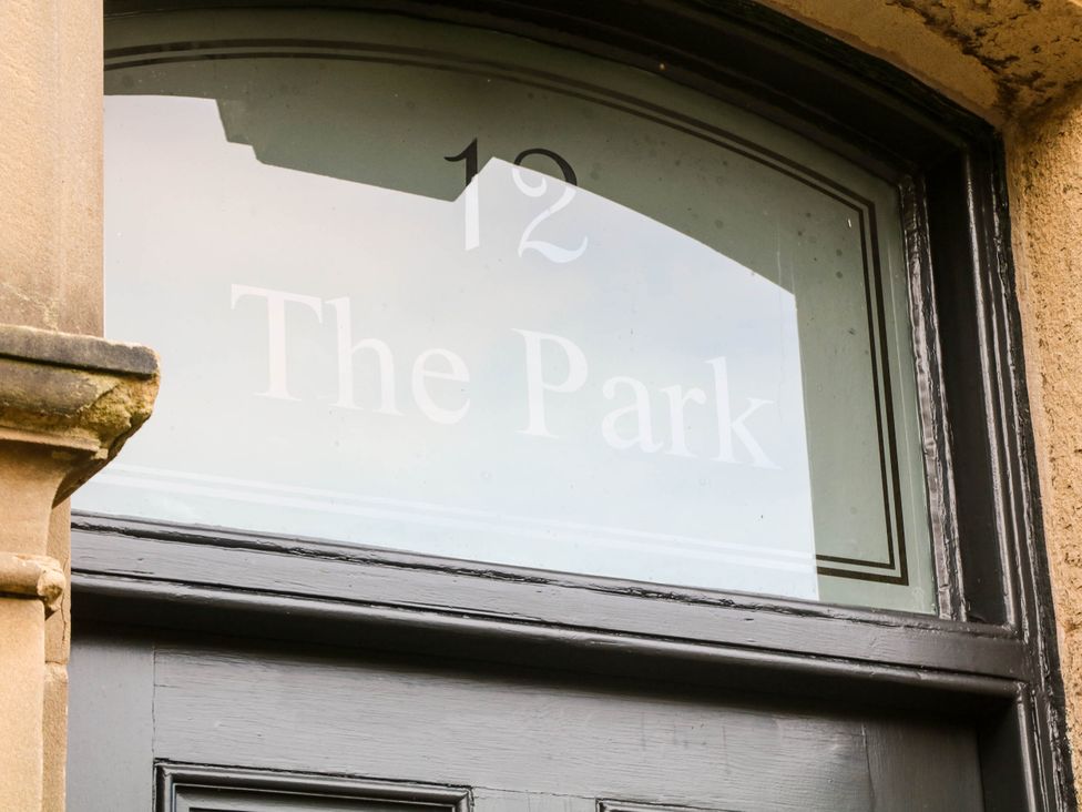 A door with a window displaying the text '12 The Park'