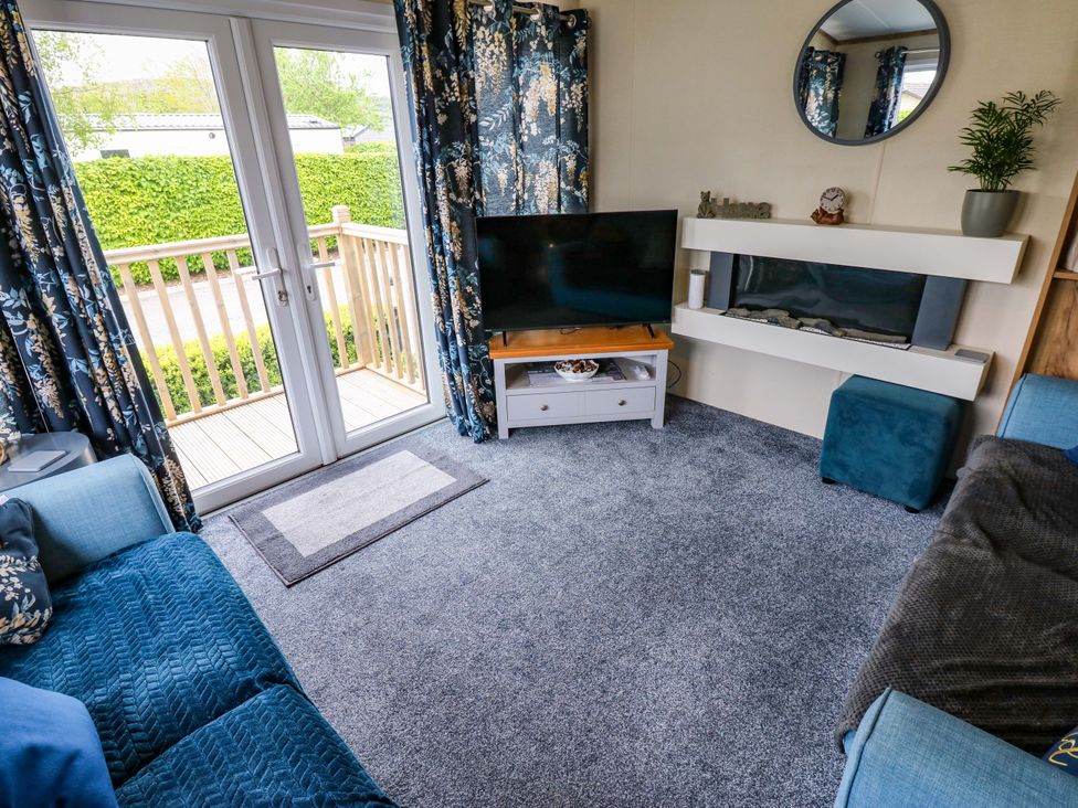 A living room with a television and sofa at Plot 41 High Hesket near Armathwaite