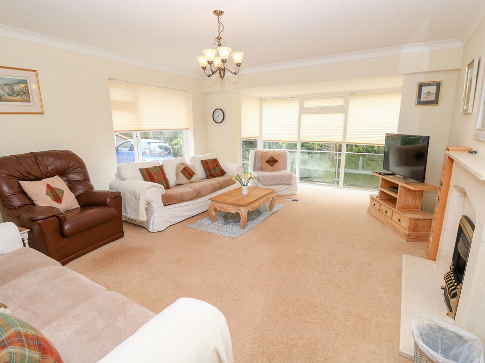 A living room with sofa and coffee table at Tall Timbers in Ventnor