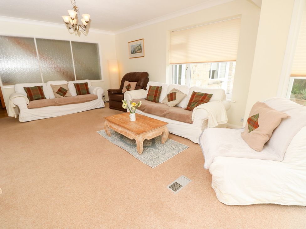 A living room with sofas and a coffee table at Tall Timbers in Ventnor