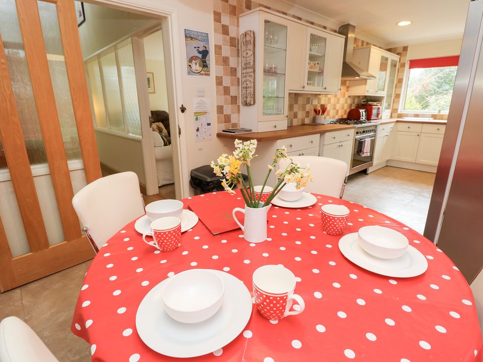 A kitchen with a dining table set at Tall Timbers in Ventnor