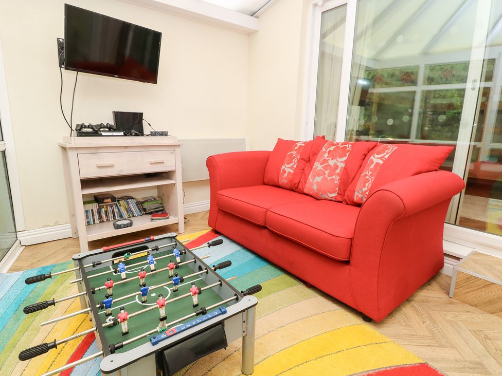 A snug with a sofa and a foosball table at Tall Timbers in Ventnor