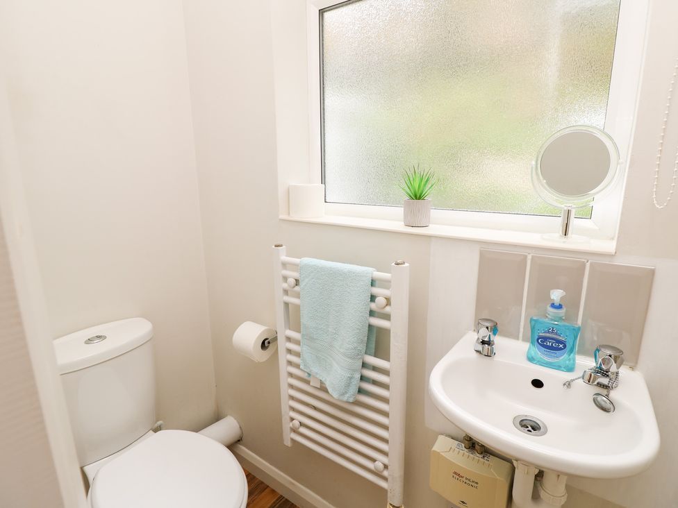 A bathroom with a toilet and sink at Tall Timbers in Ventnor