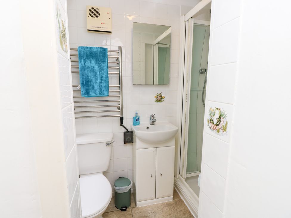 A bathroom with a sink, toilet, and shower at Tall Timbers in Ventnor