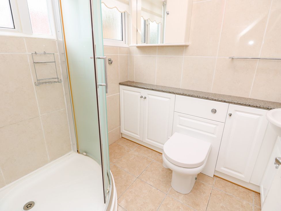A bathroom with a shower, toilet, and sink at Tall Timbers in Ventnor