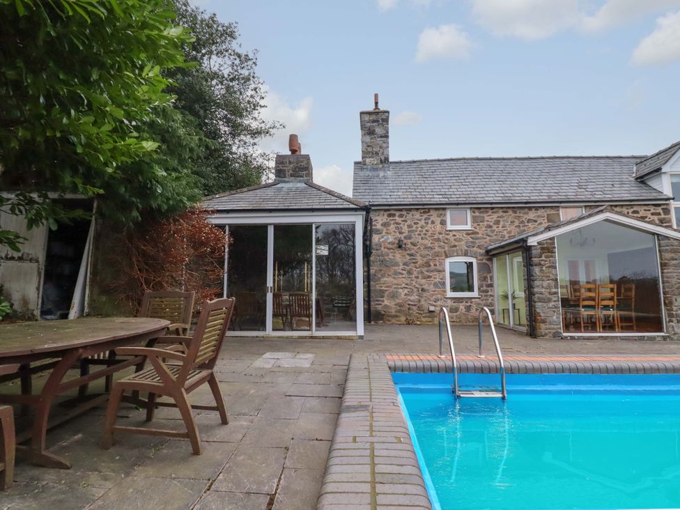 An outdoor area with a swimming pool and seating at Bryn Y Garreg - The Wireless Free Farm (No Tech!) Y Trallwng