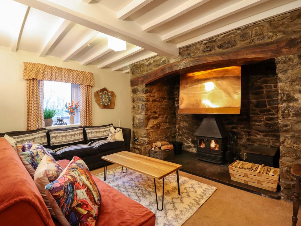 A living room with a fireplace and sofa at Bryn Y Garreg - The Wireless Free Farm (No Tech!) Y Trallwng