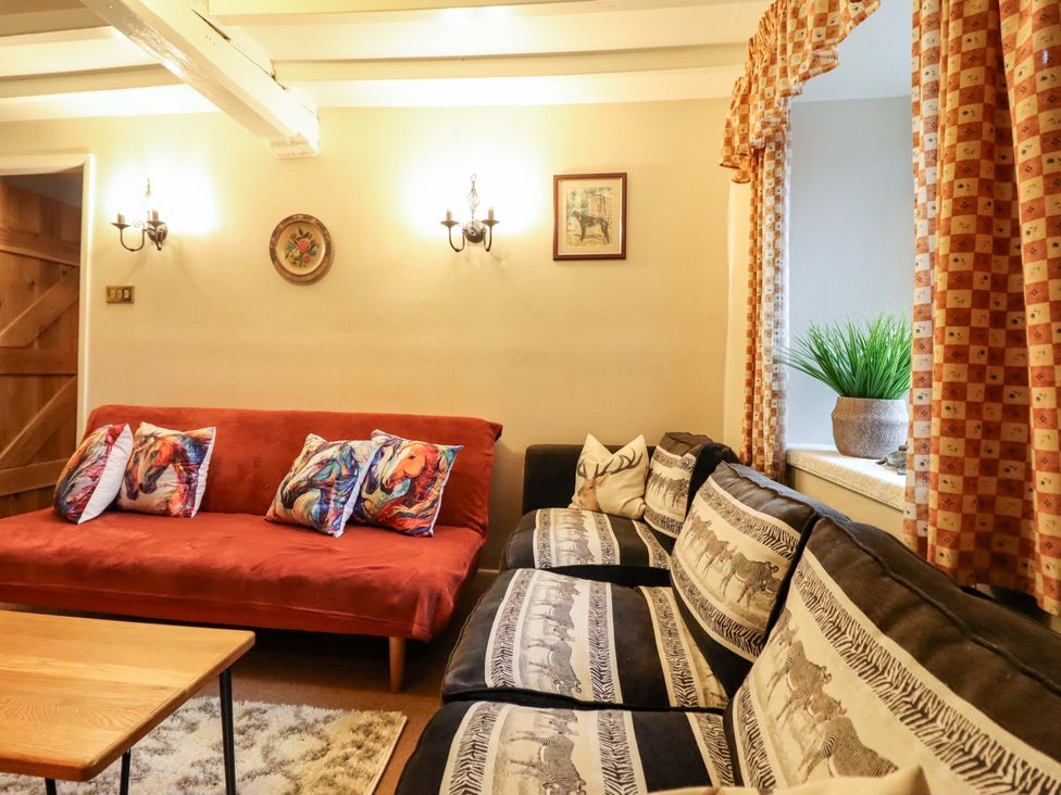 A living room with sofa and coffee table at Bryn Y Garreg - The Wireless Free Farm (No Tech!) Y Trallwng