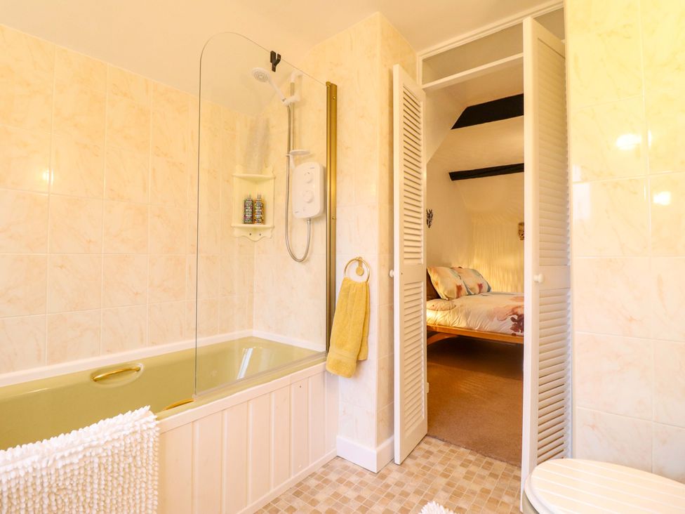 A bathroom with a bathtub and shower area at Bryn Y Garreg - The Wireless Free Farm (No Tech!) in Y Trallwng