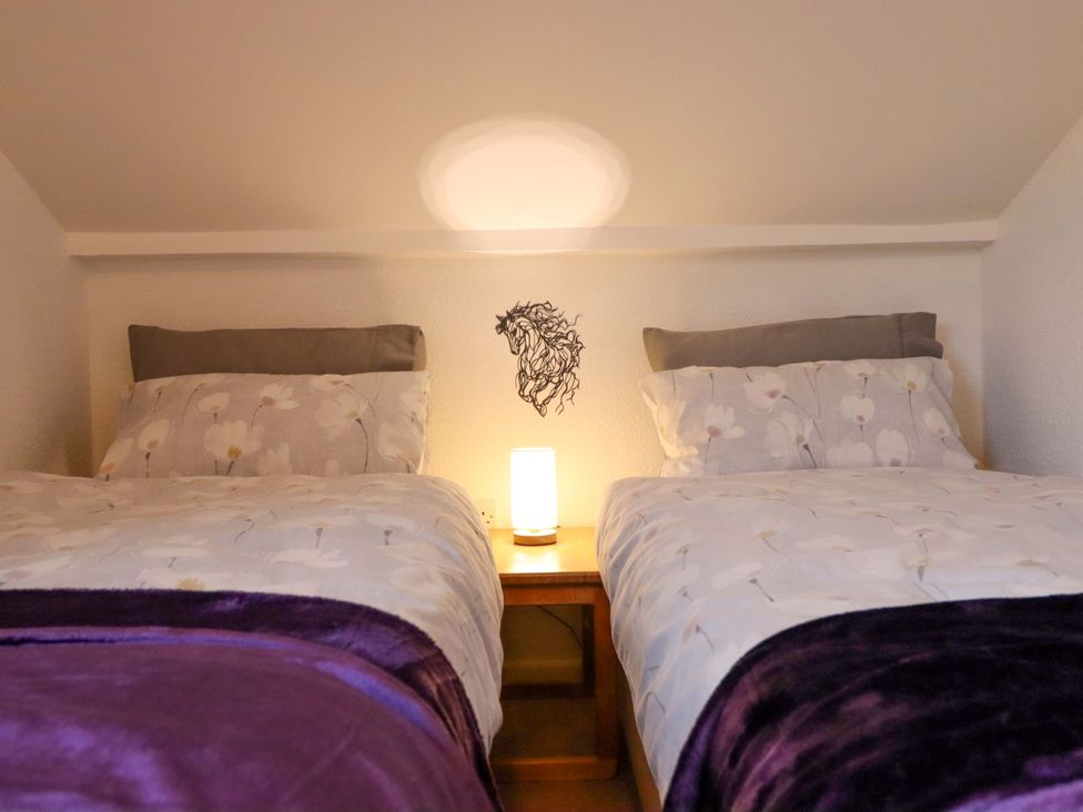 A bedroom with two beds and a lamp at Bryn Y Garreg - The Wireless Free Farm (No Tech!) Y Trallwng