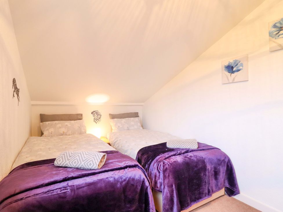 A bedroom with two beds and wall art at Bryn Y Garreg - The Wireless Free Farm (No Tech!) in Y Trallwng