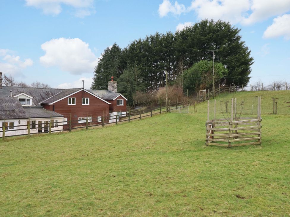 An outdoor area with a house and trees at Bryn Y Garreg - The Wireless Free Farm (No Tech!) Y Trallwng