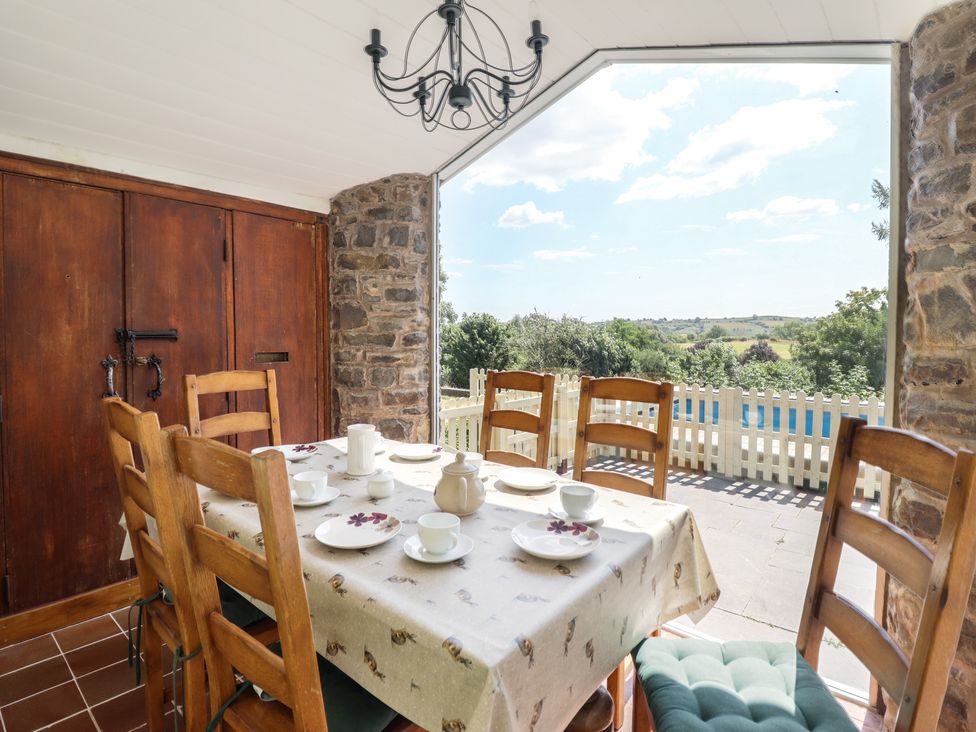 A dining room with a table set for tea at Bryn Y Garreg Cottage - The Wireless Free Farm Llangadfan near Llanwddyn
