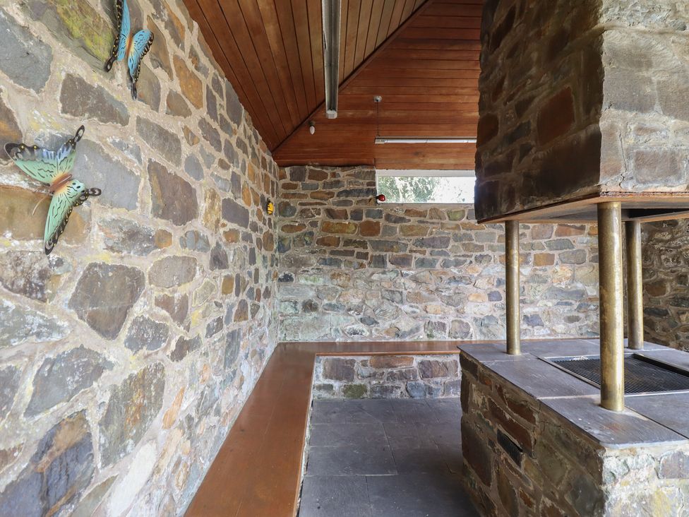 A room with stone walls and a fireplace at Bryn Y Garreg Cottage - The Wireless Free Farm Llangadfan near Llanwddyn
