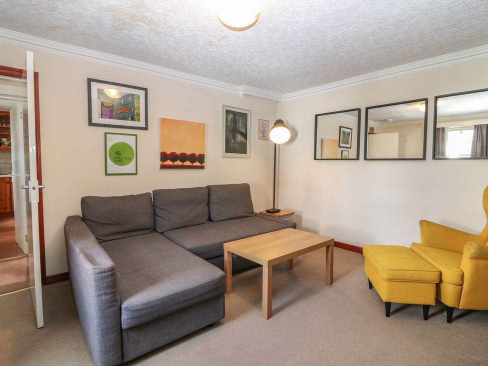 A living room with a sofa and coffee table at Footdee Cottage in Aberdeen