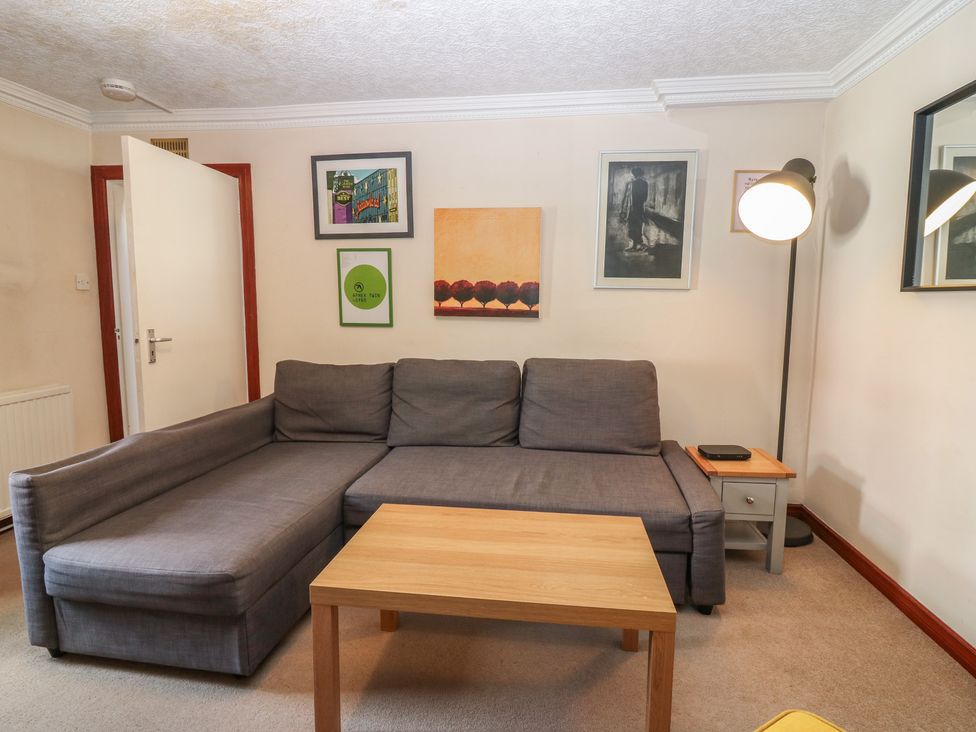 A living room with a sofa and coffee table at Footdee Cottage in Aberdeen