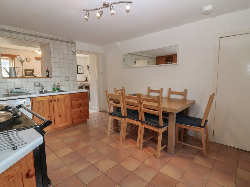 A kitchen with a dining table and chairs at Footdee Cottage in Aberdeen