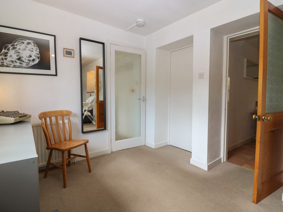 A hallway with a chair and a typewriter at Footdee Cottage, Aberdeen