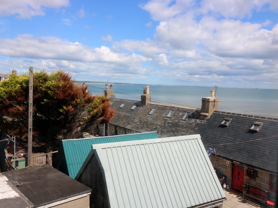 A view of rooftops and the sea from Footdee Cottage in Aberdeen