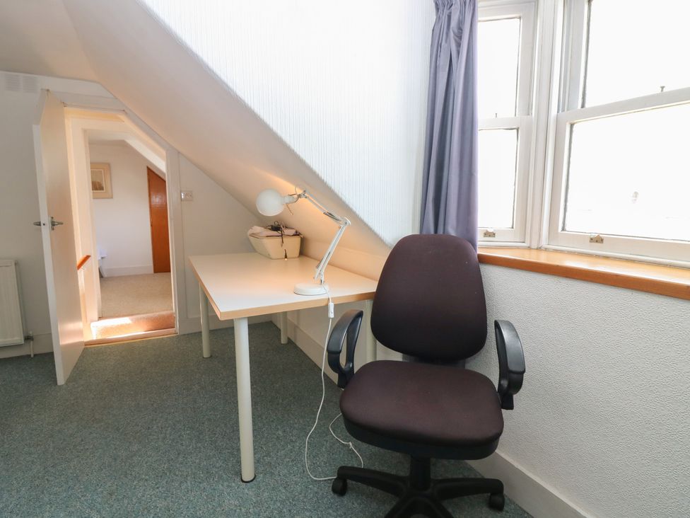An office space with a desk and chair at Footdee Cottage in Aberdeen